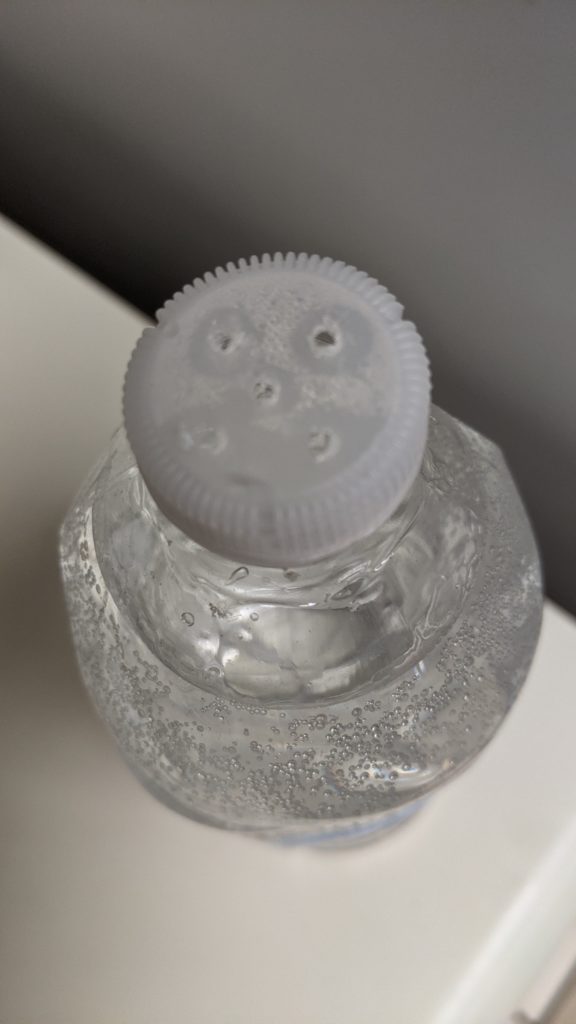 Holes on top of water bottle for hand washing