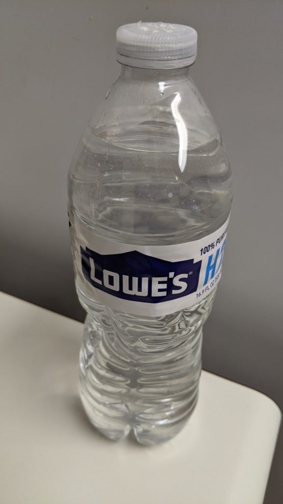 Water bottle with holes on top for hand washing