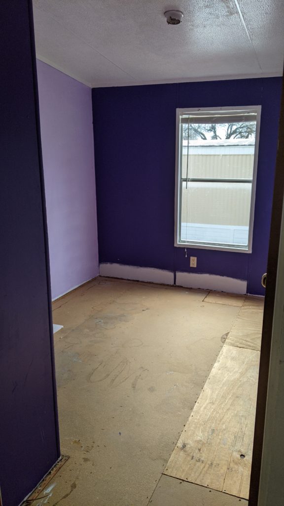 guest bedroom before painting (purple walls)