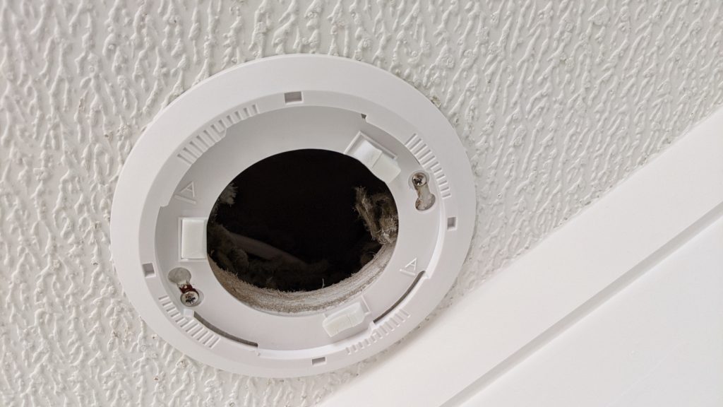 Smoke alarm plate installed kitchen ceiling (close up)