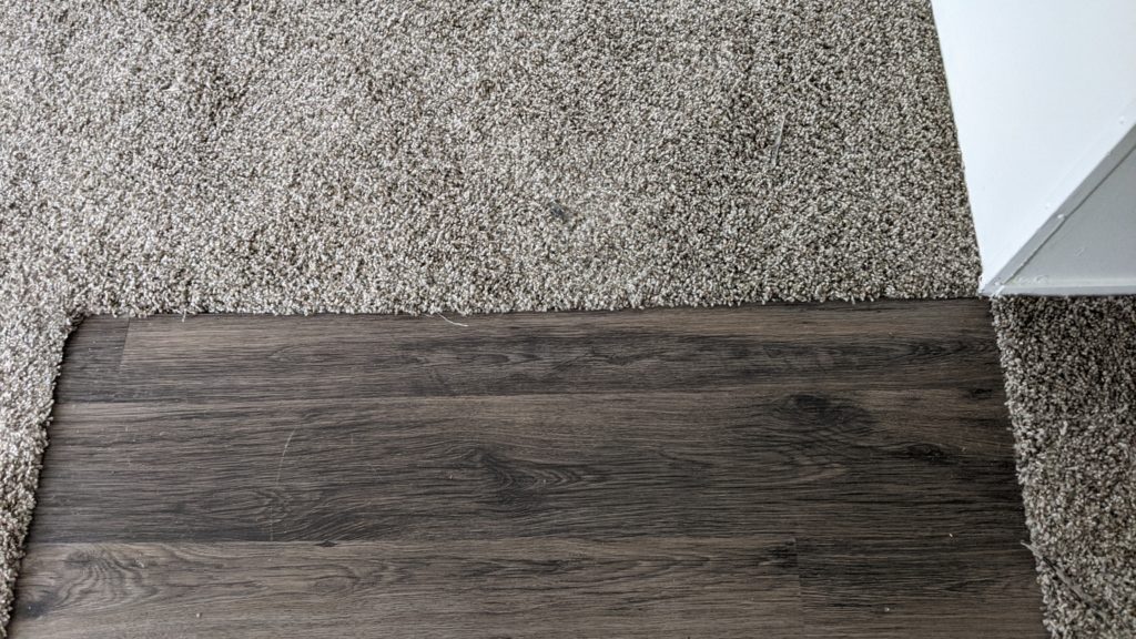 Close-up carpet and LVP plank flooring